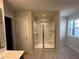 Bathroom featuring a glass enclosed shower, tile floor, and modern fixtures at 262 Depot Landing Rd # 51, Auburn, GA 30011