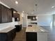 Spacious kitchen featuring granite countertops, dark cabinets, white subway tile backsplash, and stainless steel sink at 262 Depot Landing Rd # 51, Auburn, GA 30011