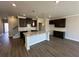 Well-lit kitchen featuring granite countertops, dark cabinets, stainless sink, and pendant lighting at 262 Depot Landing Rd # 51, Auburn, GA 30011