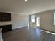 Bright living area featuring luxury vinyl plank flooring, white trim, and an adjacent kitchen at 262 Depot Landing Rd # 51, Auburn, GA 30011