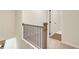 Upstairs hallway with iron railing and access to closet at 262 Depot Landing Rd, Auburn, GA 30011