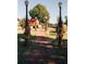 Brick pathway through a park with autumnal decorations at 262 Depot Landing Rd # 51, Auburn, GA 30011