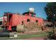 Red train caboose decorated for fall sits in a town square at 262 Depot Landing Rd, Auburn, GA 30011