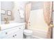 Updated bathroom with white vanity, bathtub, and patterned shower curtain at 2832 Fieldstone Se Dr, Conyers, GA 30013