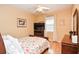 Bedroom with floral bedding, wood flooring and ceiling fan at 2832 Fieldstone Se Dr, Conyers, GA 30013