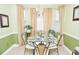 Bright breakfast nook with a glass table and bay window at 2832 Fieldstone Se Dr, Conyers, GA 30013