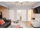 Cozy living room featuring a comfortable sofa and a view into the laundry room and bathroom at 2832 Fieldstone Se Dr, Conyers, GA 30013