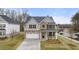 Two-story home with brick and siding, gray trim, and a two-car garage at 13218 E Tolstoy Se Drs, Covington, GA 30014