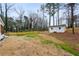 Grassy backyard featuring a new fence, storage shed, and mature trees at 467 Concord Sw Rd, Smyrna, GA 30082