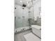 Bright bathroom with frameless shower, soaking tub, neutral tile, and modern fixtures at 467 Concord Sw Rd, Smyrna, GA 30082