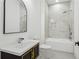 Modern bathroom features marble tile, black and gold vanity, and a soaking tub at 467 Concord Sw Rd, Smyrna, GA 30082