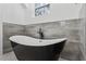 Sleek black and white soaking tub set against gray tile, creating a spa-like experience at 467 Concord Sw Rd, Smyrna, GA 30082