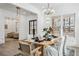 Sun-filled dining room with modern light fixture above wooden table, and open access to the living room area at 467 Concord Sw Rd, Smyrna, GA 30082