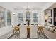 Bright dining room featuring modern lighting, a wooden table set for six, and lots of natural light from three windows at 467 Concord Sw Rd, Smyrna, GA 30082