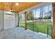 Covered patio with fan, open view of fenced backyard and a ceiling made of wood at 467 Concord Sw Rd, Smyrna, GA 30082