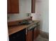 Kitchen with wood cabinets, dishwasher, and double sink at 1604 Pine Tree Trl, Atlanta, GA 30349