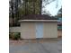 Tan storage shed with gray door at 1604 Pine Tree Trl, Atlanta, GA 30349