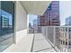 Condo balcony with views of city buildings, a metal railing and neutral flooring at 20 10Th Nw St # 901, Atlanta, GA 30309