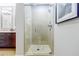 Elegant bathroom with glass shower, tile surround, modern fixtures, and neutral tones at 20 10Th Nw St # 901, Atlanta, GA 30309