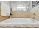 Luxurious soaking tub with tile surround and modern fixtures, perfect for relaxation at 20 10Th Nw St # 901, Atlanta, GA 30309
