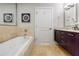 Bright bathroom features a large soaking tub with tile surround, and modern vanity at 20 10Th Nw St # 901, Atlanta, GA 30309