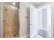 Walk in shower features neutral colored tiles, next to a white door and light colored flooring at 20 10Th Nw St # 901, Atlanta, GA 30309