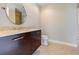 Modern bathroom features a vanity with white countertop, dark wood cabinets and a tiled floor at 20 10Th Nw St # 901, Atlanta, GA 30309