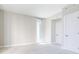 Bright bedroom with plush carpet, neutral walls, and a sliding glass door leading to a balcony at 20 10Th Nw St # 901, Atlanta, GA 30309
