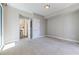 Spacious bedroom with neutral walls, plush carpet, and an open doorway to another room at 20 10Th Nw St # 901, Atlanta, GA 30309