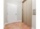 Building hallway next to an elevator, with tiled flooring and a fire emergency exit at 20 10Th Nw St # 901, Atlanta, GA 30309