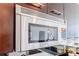 Close up of Viking stainless steel microwave in kitchen with black countertops at 20 10Th Nw St # 901, Atlanta, GA 30309