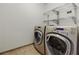 Well-equipped laundry room with modern washer and dryer, and convenient shelving at 20 10Th Nw St # 901, Atlanta, GA 30309