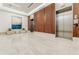 Modern lobby boasts sleek tile floors, wood accents, seating, and elevator access at 20 10Th Nw St # 901, Atlanta, GA 30309