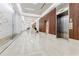 Elegant lobby area with marble floors, sleek elevator access and modern decor at 20 10Th Nw St # 901, Atlanta, GA 30309