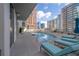 Outdoor pool area with lounge chairs and city views in the background at 20 10Th Nw St # 901, Atlanta, GA 30309