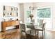 Bright dining room with glass table, chairs, and hardwood floors at 255 Grogans Lake Pt, Atlanta, GA 30350