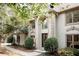 Two-story house with light beige siding, arched entryway, and landscaping at 255 Grogans Lake Pt, Atlanta, GA 30350