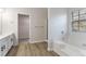 Main bathroom with a garden tub, walk-in shower, and double vanity at 2839 Suttonwood Way, Buford, GA 30519