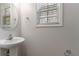 Small bathroom with pedestal sink and a window at 2839 Suttonwood Way, Buford, GA 30519