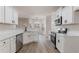 Modern kitchen with white cabinets, stainless steel appliances, and quartz countertops at 2839 Suttonwood Way, Buford, GA 30519