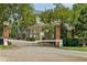 Gated community entrance with brick columns and landscaping at 375 Highland Ave # 202, Atlanta, GA 30312