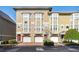 Tan three-story townhouses with attached garages and manicured landscaping at 375 Highland Ave # 202, Atlanta, GA 30312