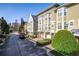 Townhouse community with parking and city skyline in background at 375 Highland Ave # 202, Atlanta, GA 30312