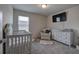 Bedroom with crib, armchair, and dresser at 419 Murphy Ave, Canton, GA 30114