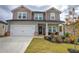 Two-story house with gray siding, a brick base, and a welcoming front porch at 419 Murphy Ave, Canton, GA 30114