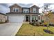 Two-story house with gray siding, white double doors, and a large yard at 419 Murphy Ave, Canton, GA 30114