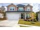 Two-story house with gray siding, a brick base, and a welcoming front porch at 419 Murphy Ave, Canton, GA 30114