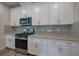 White shaker cabinets and stainless steel appliances in this kitchen at 419 Murphy Ave, Canton, GA 30114