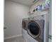 Laundry room with washer, dryer, and storage shelves at 419 Murphy Ave, Canton, GA 30114