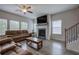 Spacious living room featuring hardwood floors, a fireplace, and large windows at 419 Murphy Ave, Canton, GA 30114